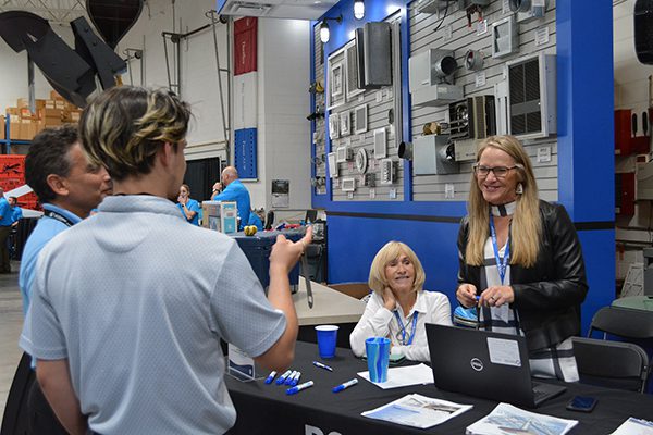 Jamie and her mom  greeting attendees at their booth